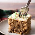 Pushing a fork into a slice of cake to get a bite.