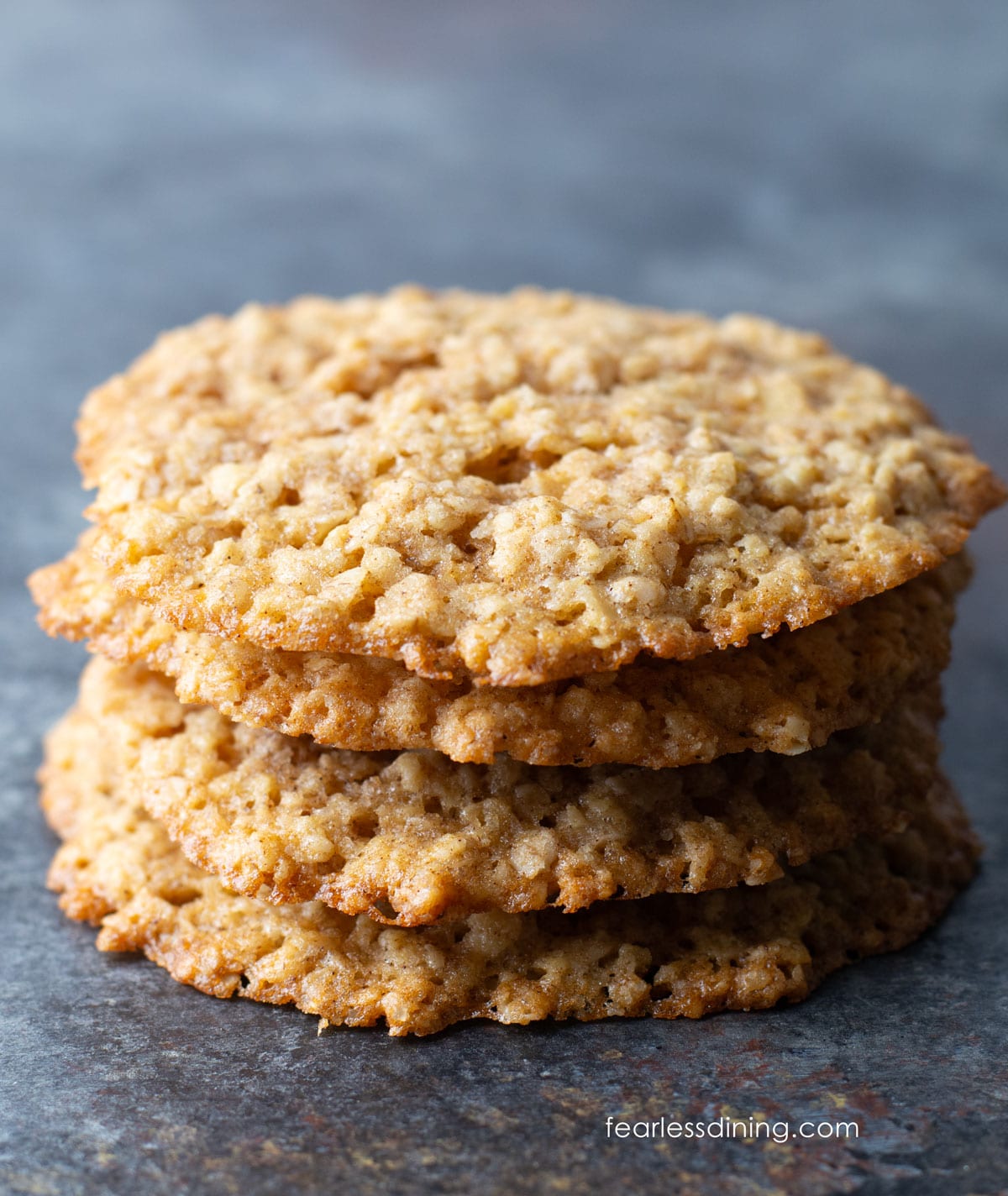 A stack of four gluten free oatmeal lace cookies.