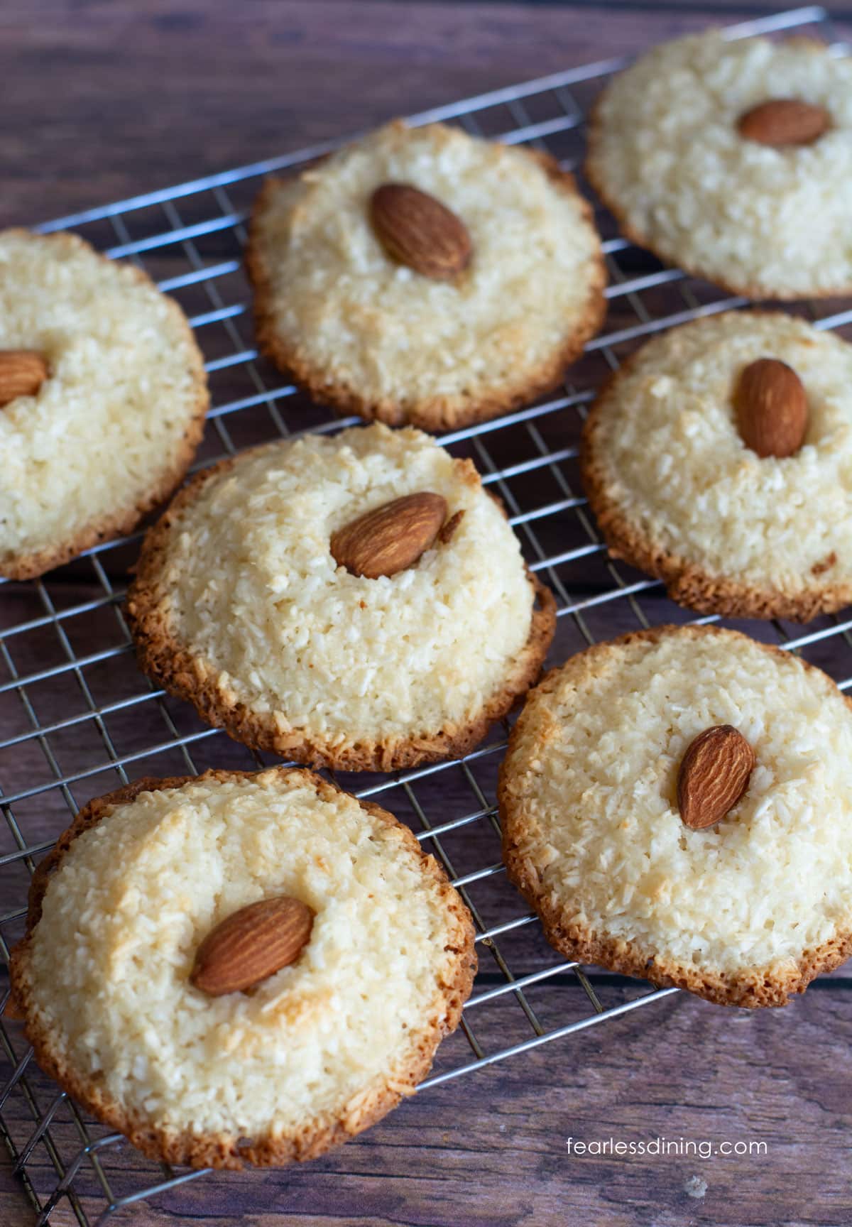 Baked gluten-free coconut cookies on a cooling rack.
