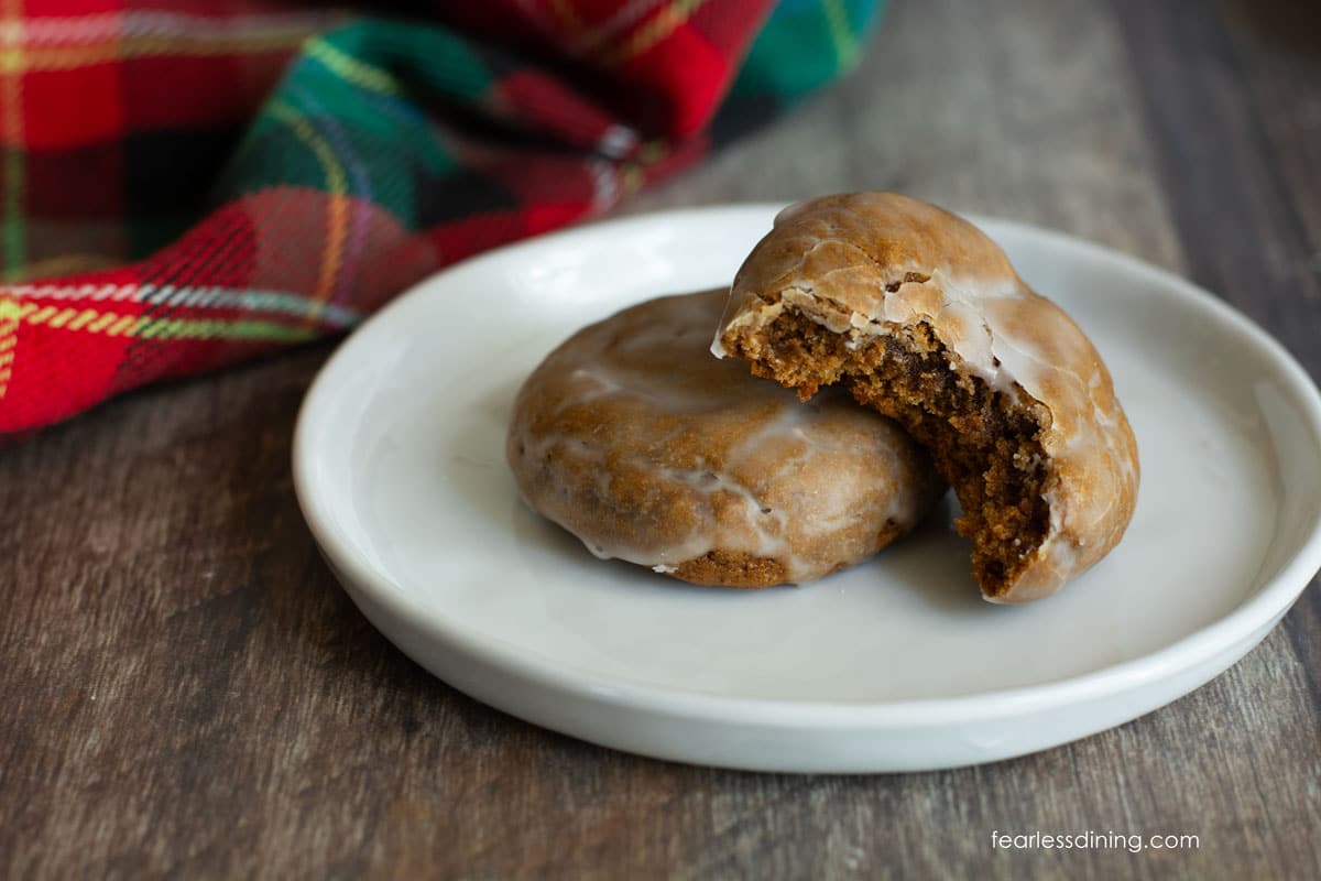 Two lebkuchen on a small plate. One has a bite taken out.