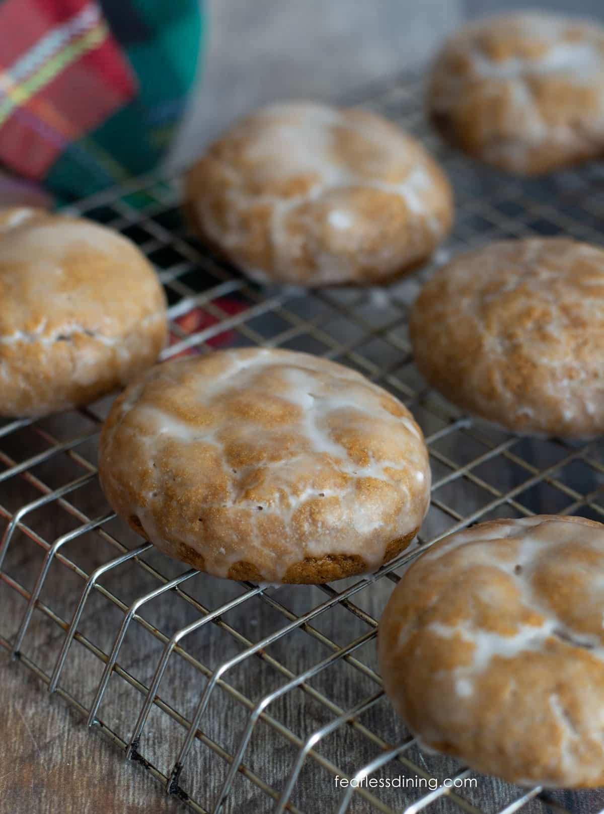 Iced gluten free lebkuchen cookies on a cooling rack.