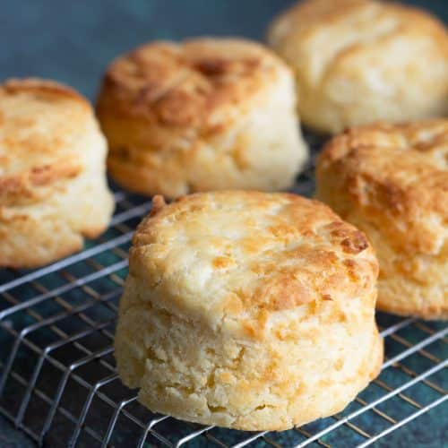 A rack with gluten free air fryer biscuits cooling on a rack.