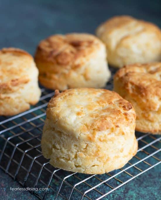 A rack with gluten free air fryer biscuits cooling on a rack.