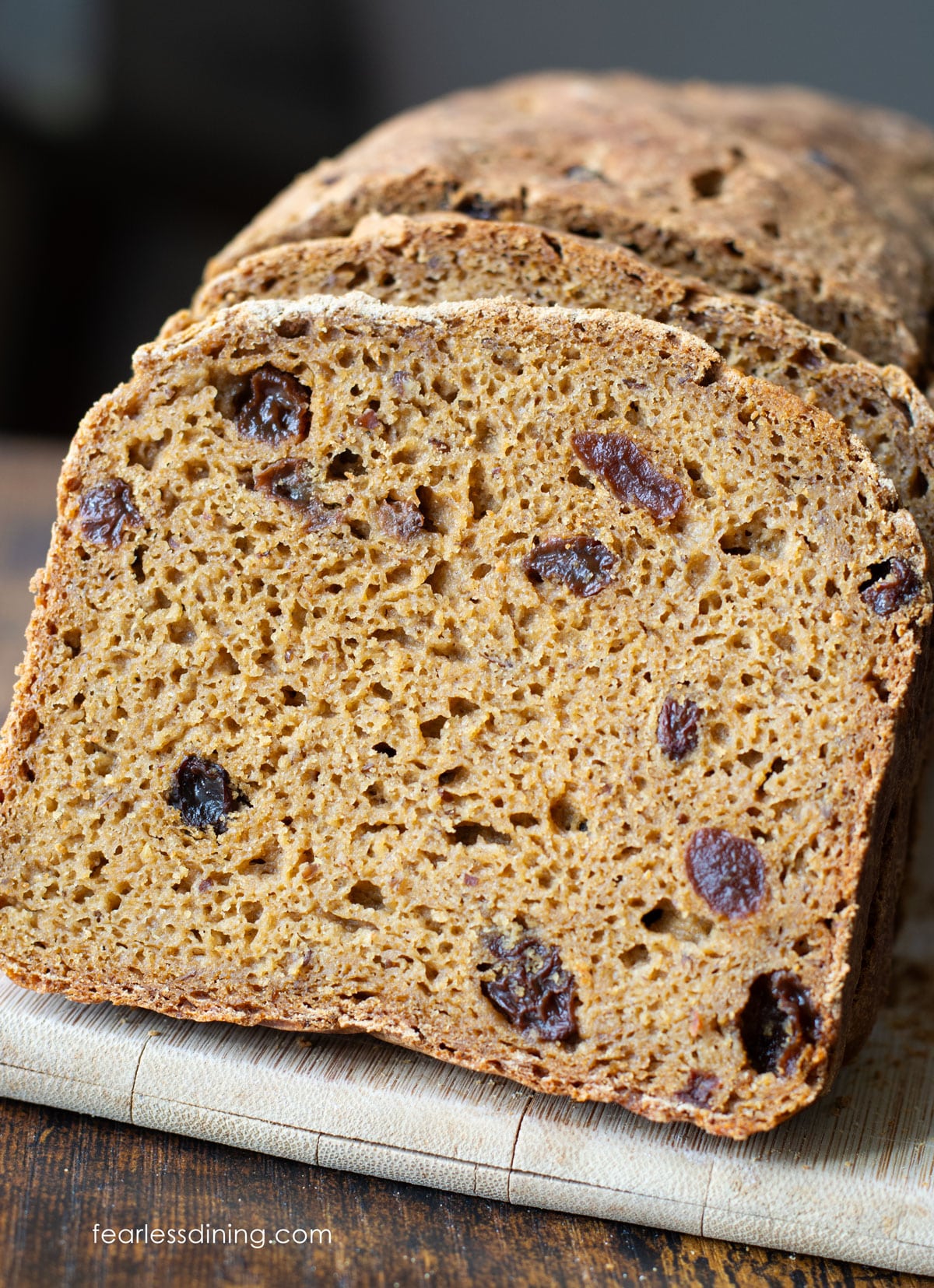 Slices of the gluten free Boston brown bread on a cutting board.
