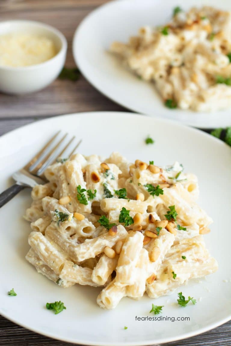 Two plates of gluten free lemon ricotta pasta.