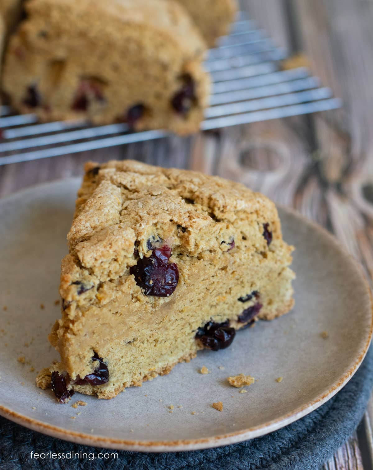 A gluten-free scone with sourdough discard on a plate.