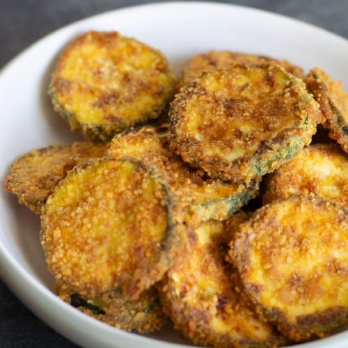 A bowl of crisp gluten free air fryer zucchini chips.
