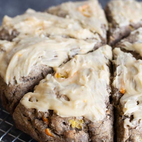 Iced gluten free buckwheat kumquat scones on a cooling rack.
