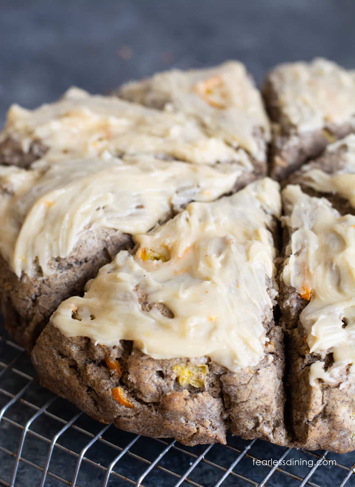 Iced gluten free buckwheat kumquat scones on a cooling rack.