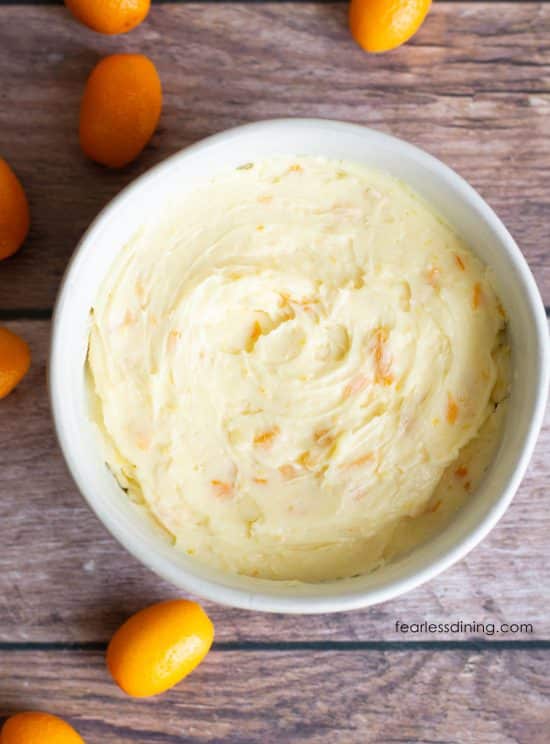A closeup of the creamy kumquat honey butter in a white bowl.