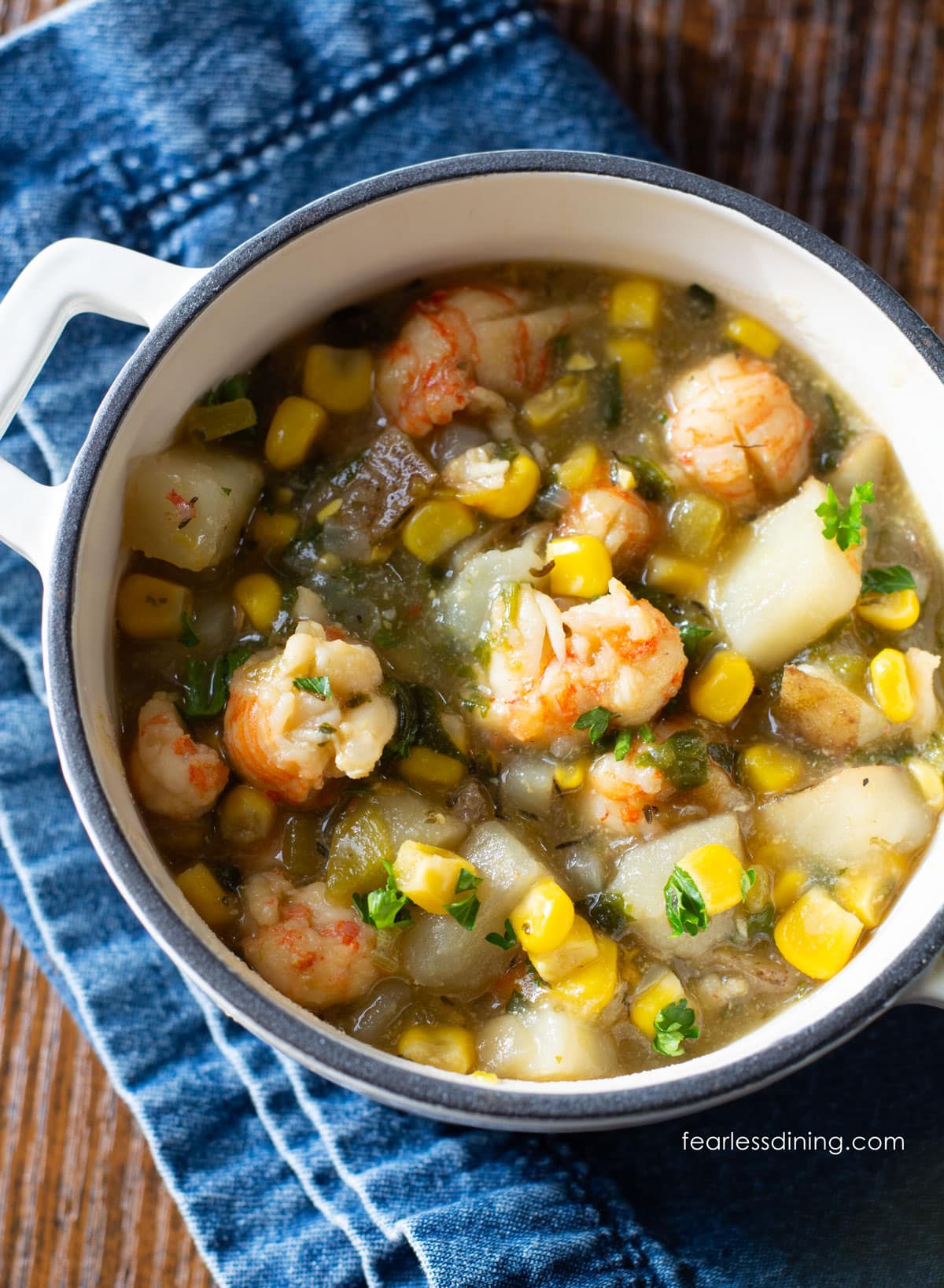 A photo of the crawfish corn soup in a white bowl.