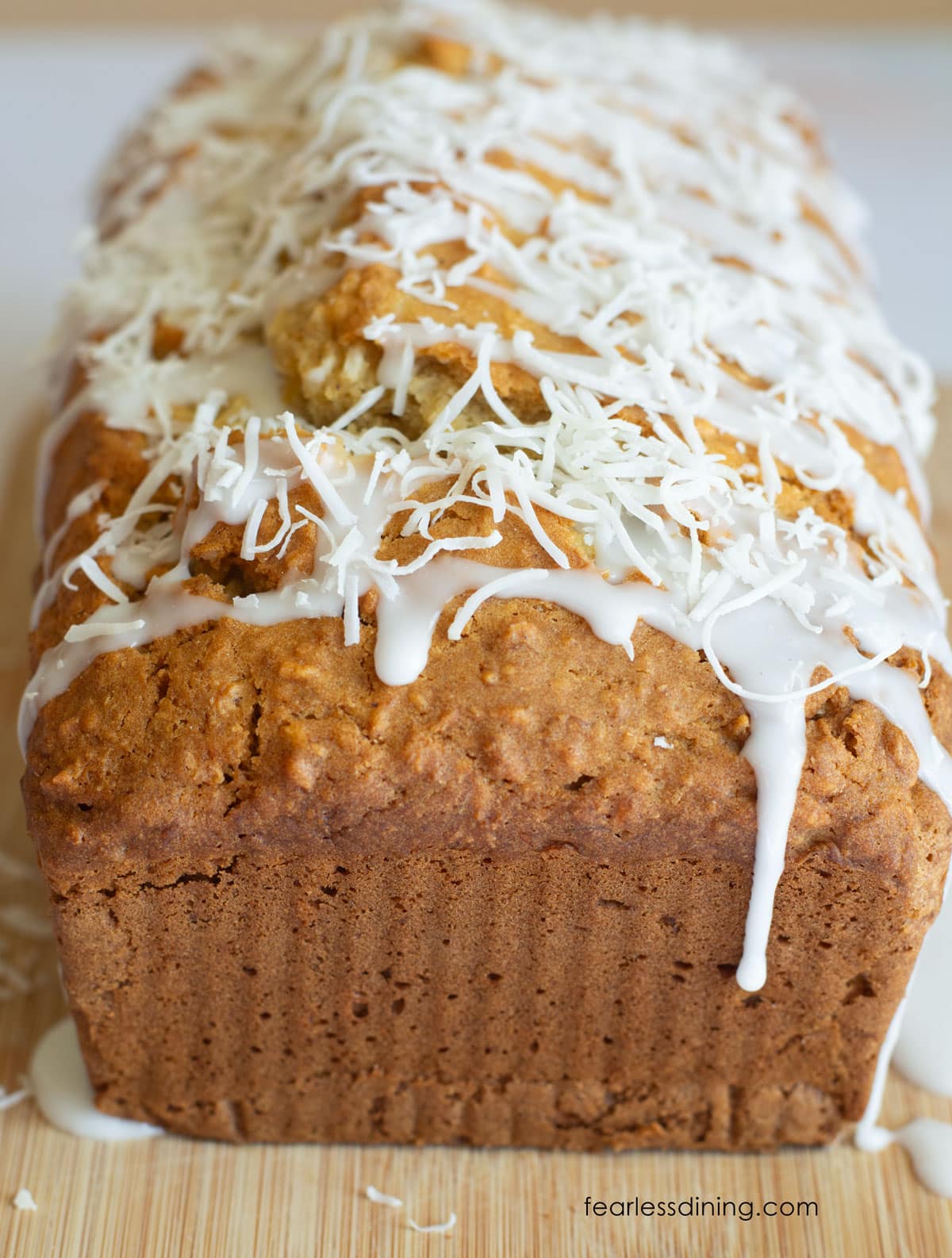 The coconut cake with the icing and shredded coconut on top.