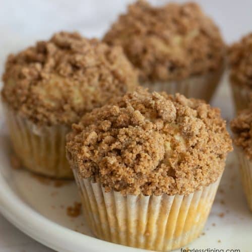 A white plate with gluten-free coffee cake muffins on it.