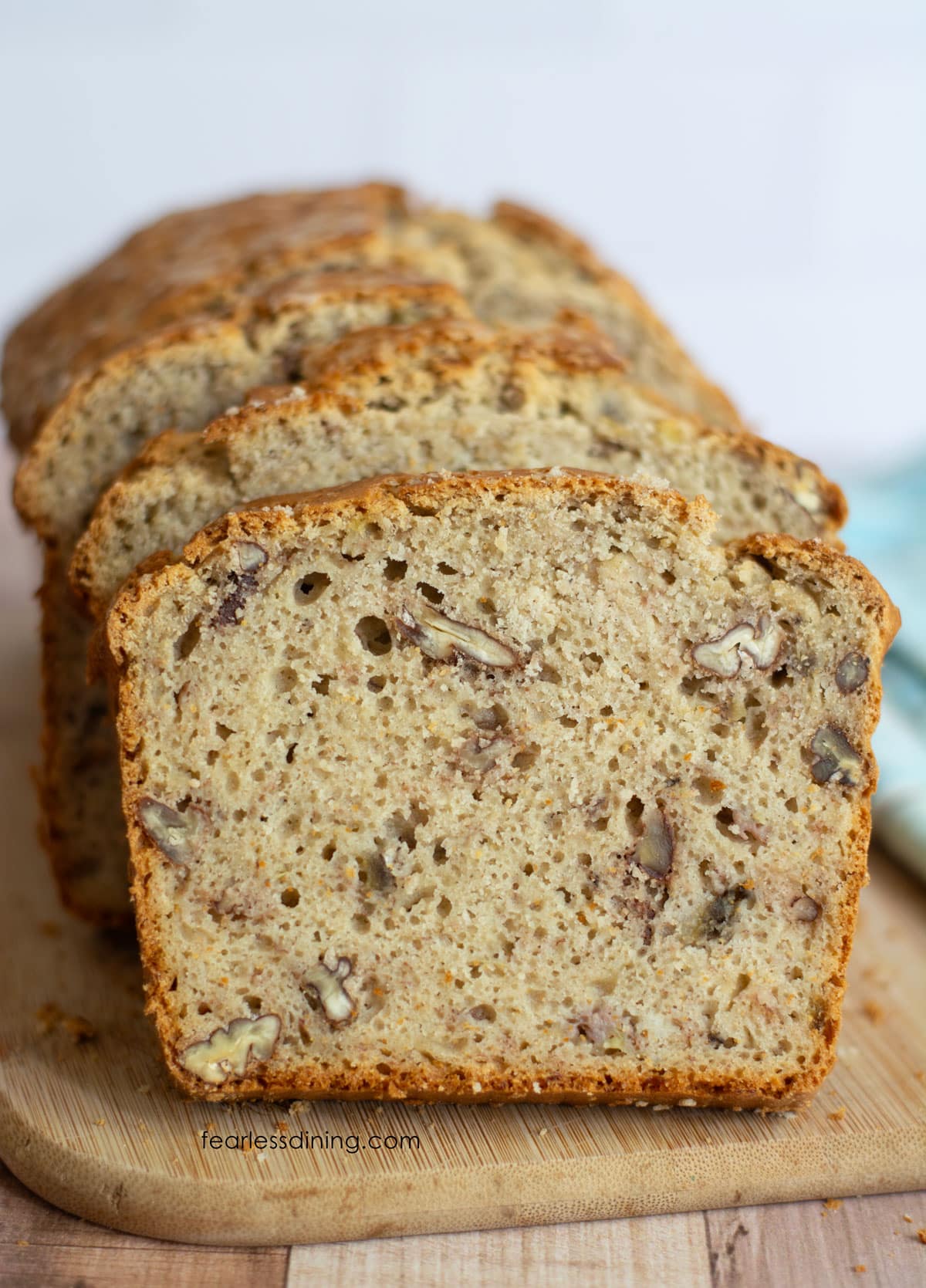 A sliced loaf of gluten-free sourdough banana bread on a cutting board.