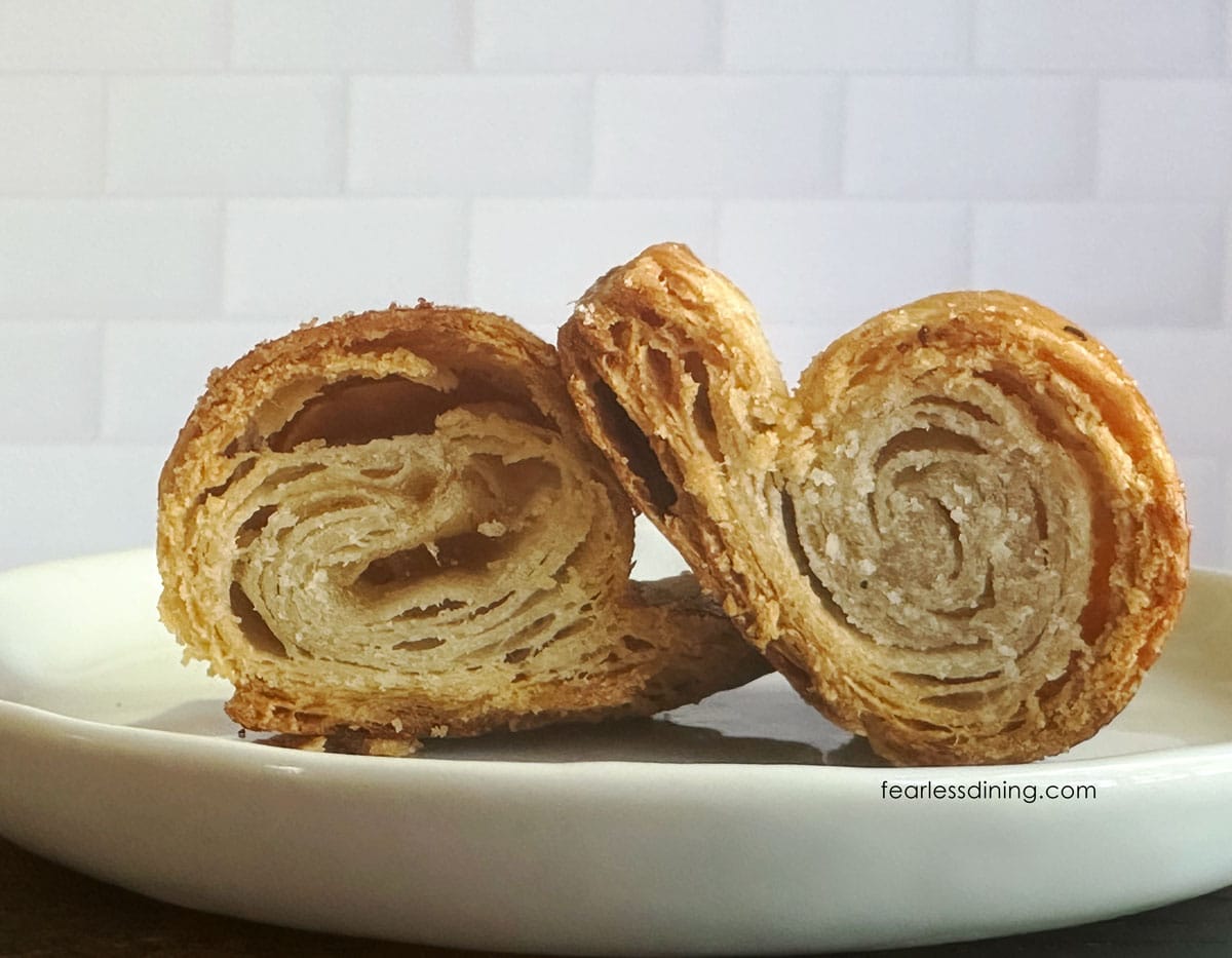 A gluten-free dairy-free rough puff pastry cut in half so you can see the flaky layers.