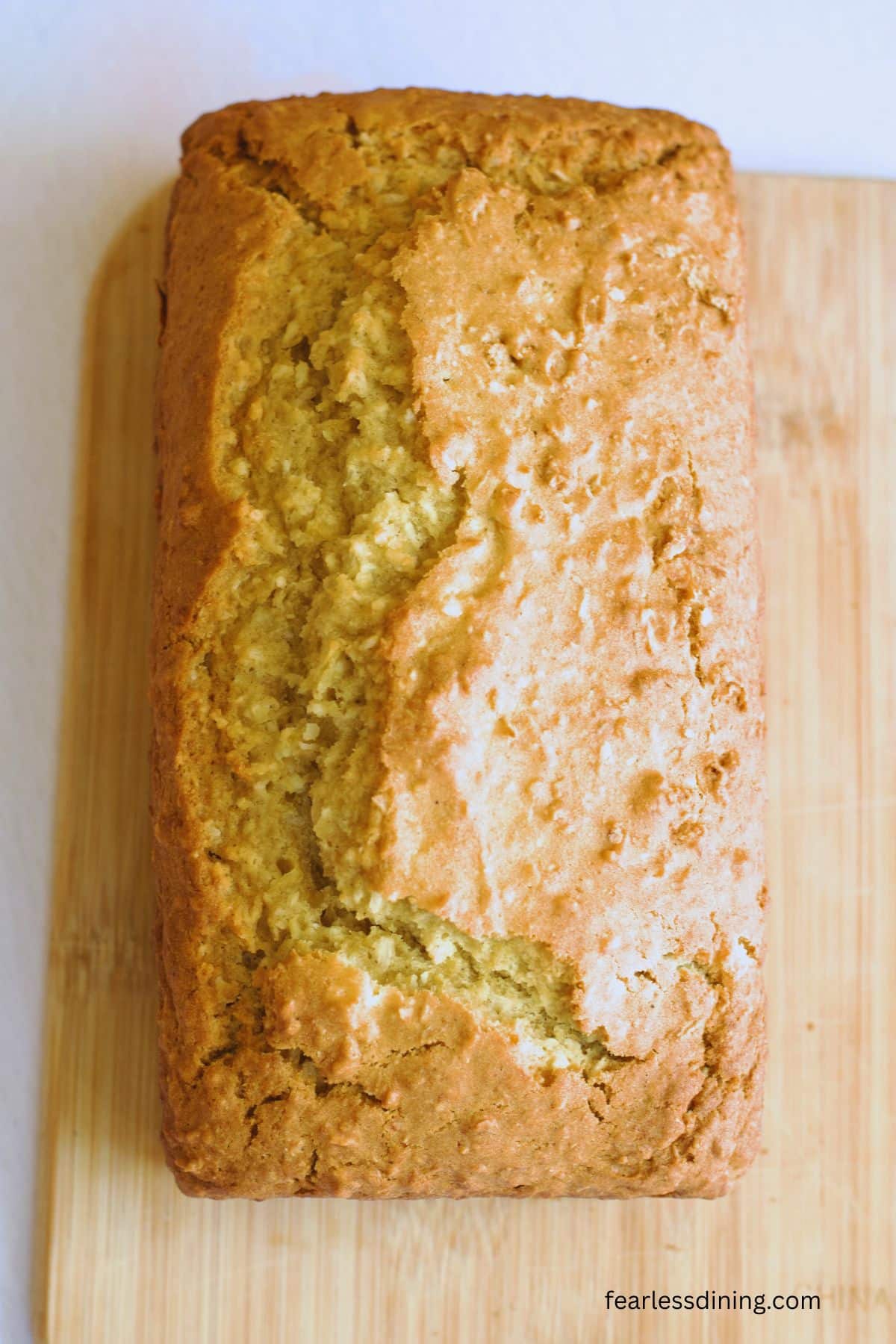 A baked pineapple coconut cake on a cutting board.