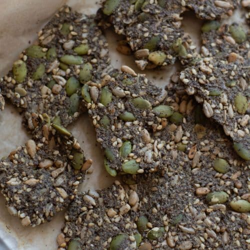 Baked seed crackers on a baking sheet.