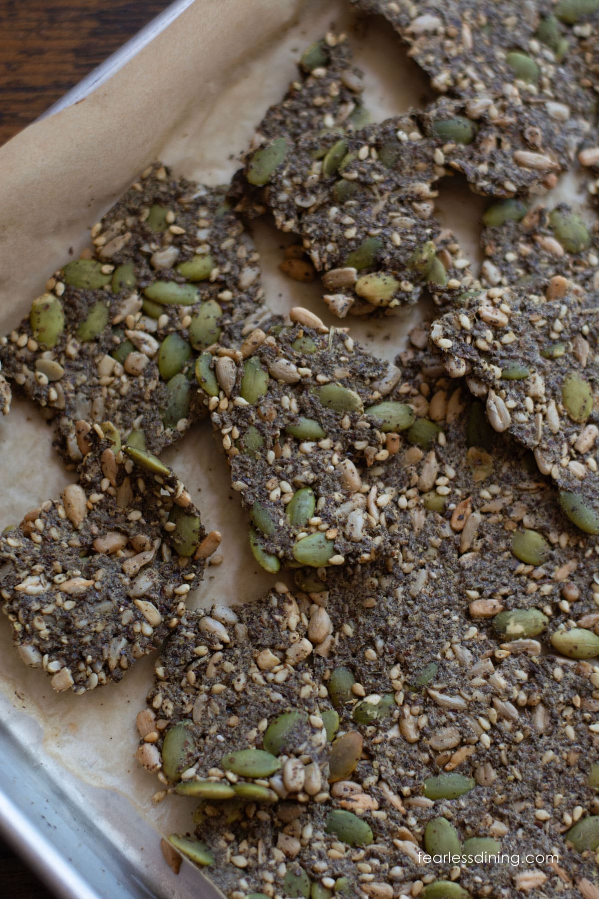 Baked seed crackers on a baking sheet.