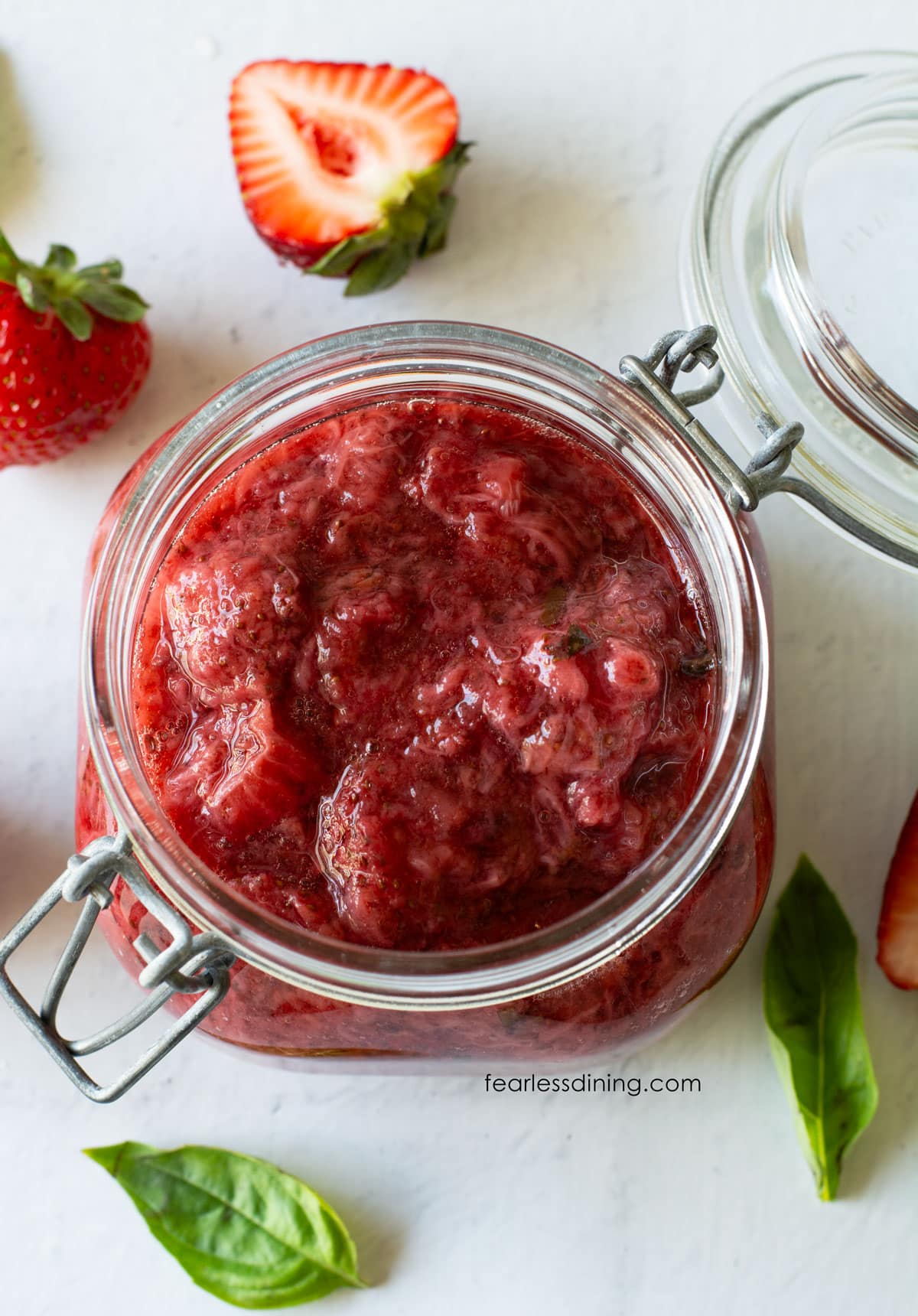 The top view of the strawberry basil compote in a mason jar.