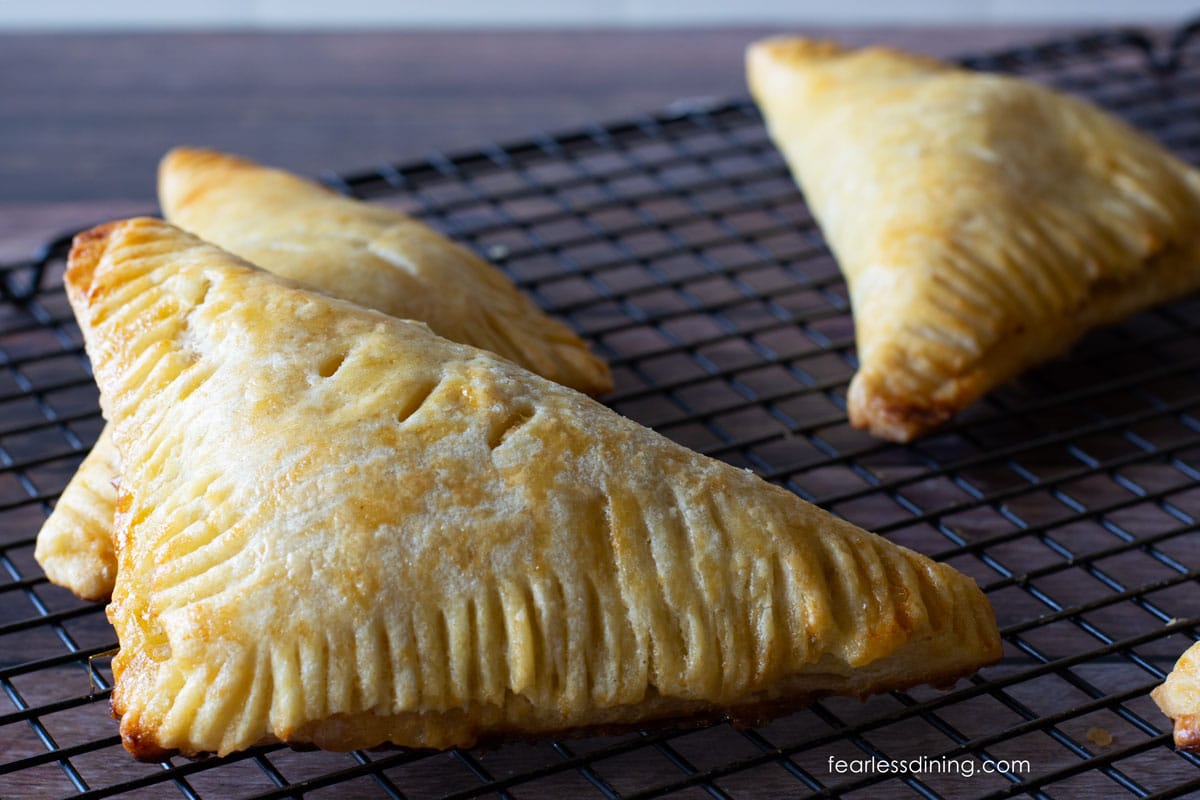 Photos of cooled gluten-free apple turnovers on a wire cooling rack.