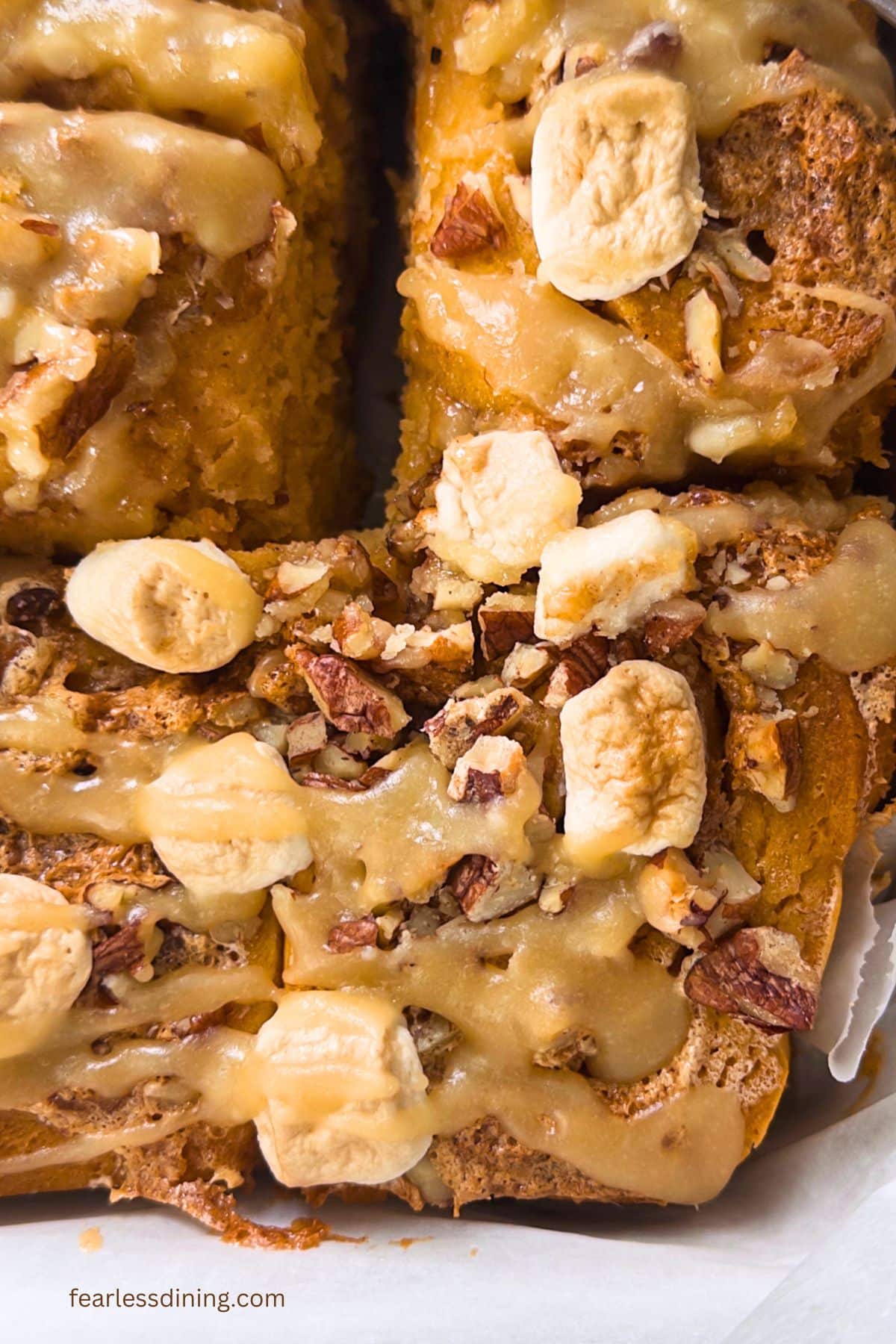 A close up of the iced cinnamon rolls in the baking dish.