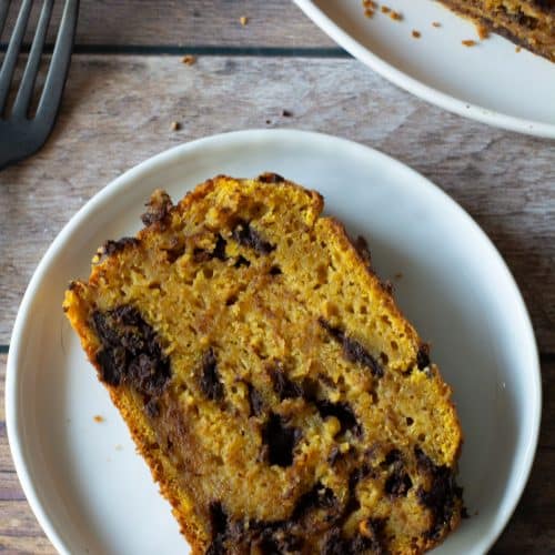 A slice of gluten-free banana pumpkin bread on a small white plate.