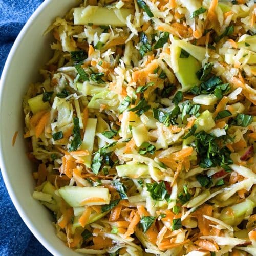 The top view of a large salad bowl filled with the celery root and apple slaw.