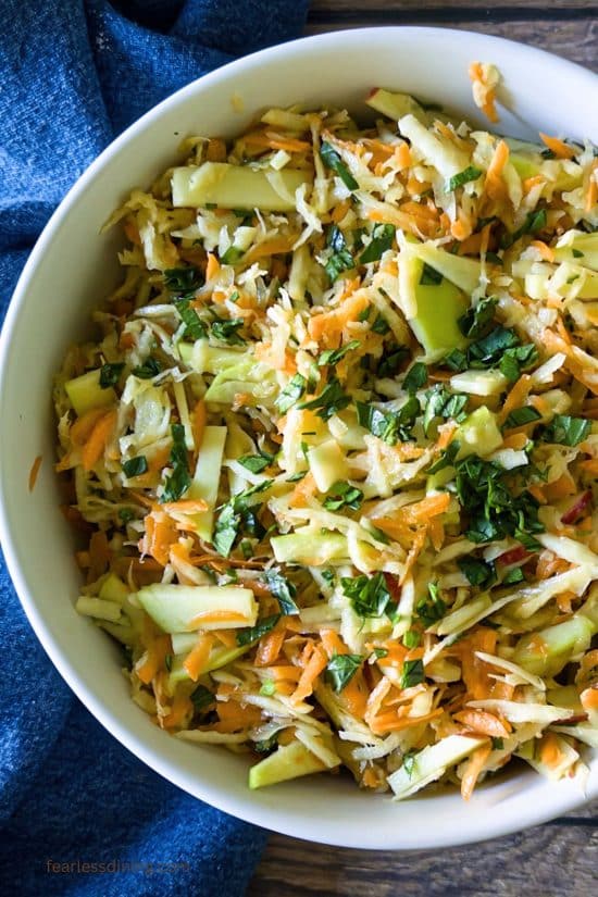 The top view of a large salad bowl filled with the celery root and apple slaw.
