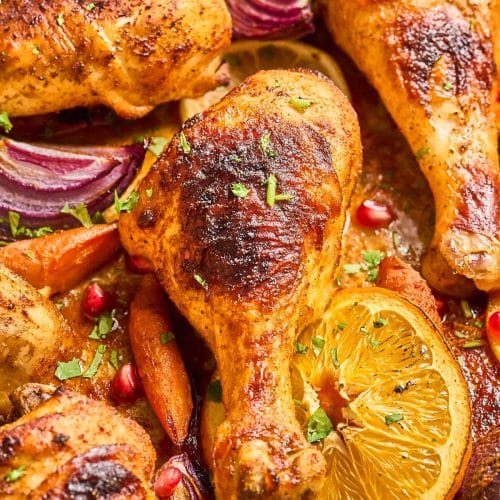 A closeup of the chicken drumstick chicken legs cooked on the sheet pan.
