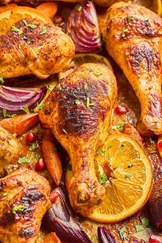A closeup of the chicken drumstick chicken legs cooked on the sheet pan.
