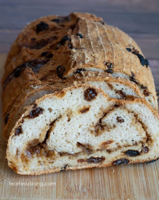 The front view of a sliced loaf of gluten-free artisan cinnamon raisin bread.