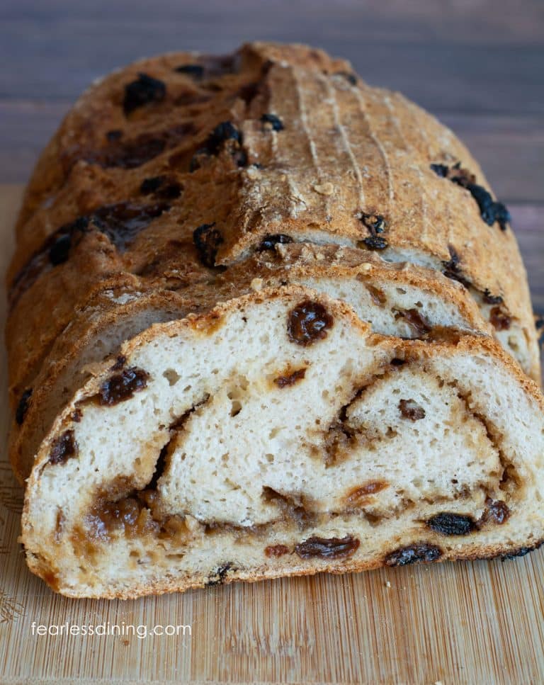The front view of a sliced loaf of gluten-free artisan cinnamon raisin bread.