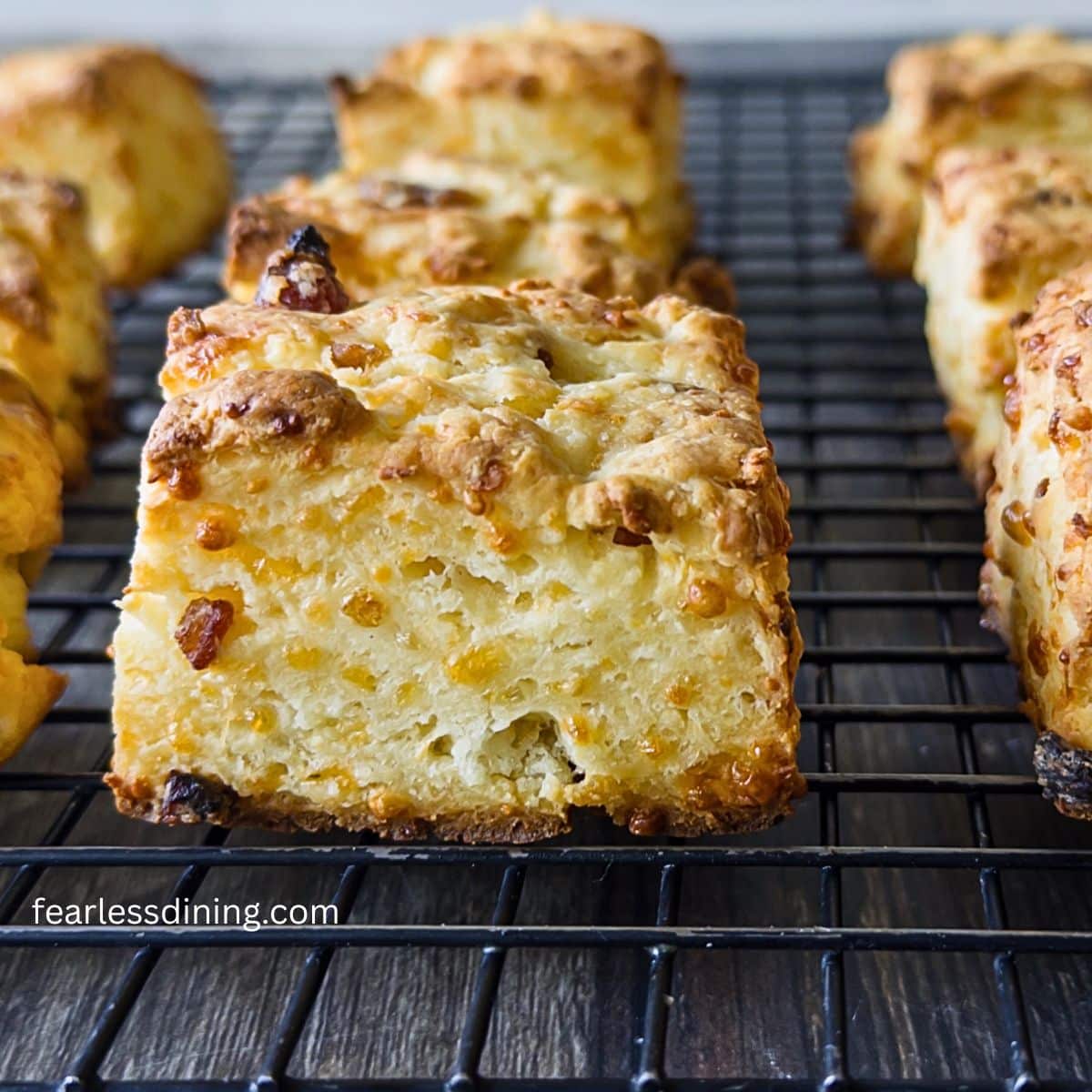 Gluten free cheddar bacon biscuits on a cooling rack.