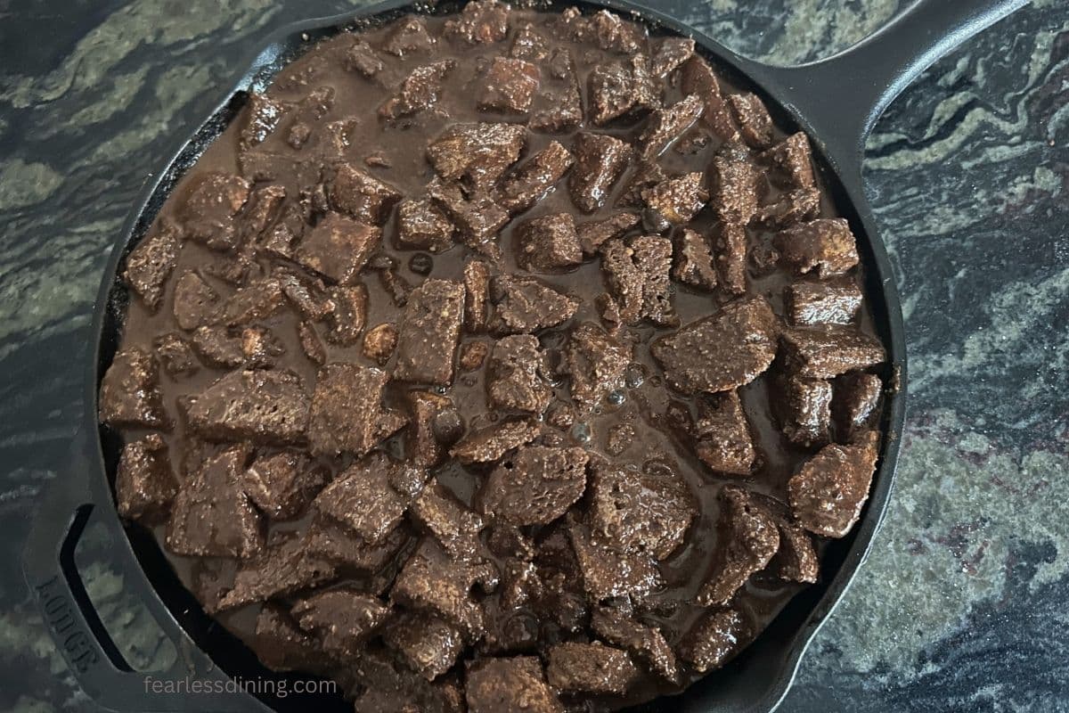 The chocolate soaked bread cubes in a greased cast iron skillet.