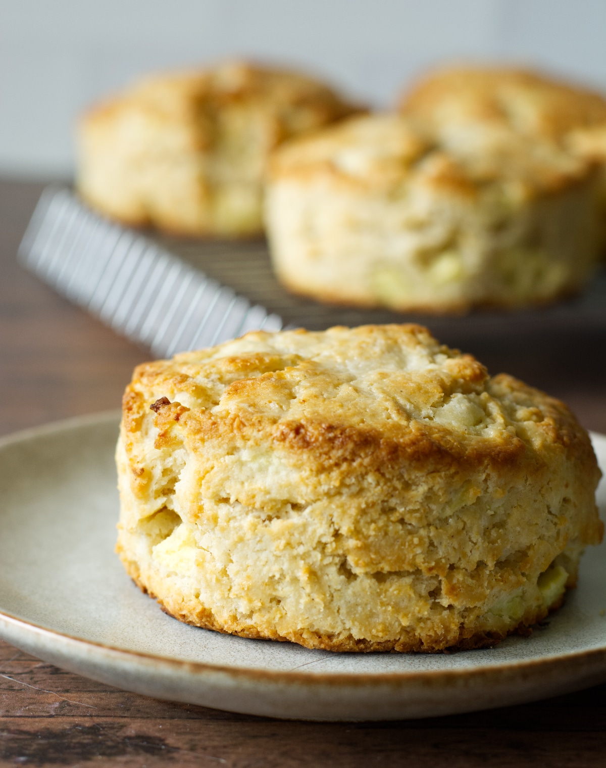 A gluten-free apple biscuit on a small plate.