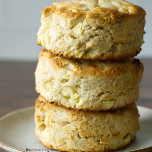 A stack of three gluten free apple biscuits on a small plate.