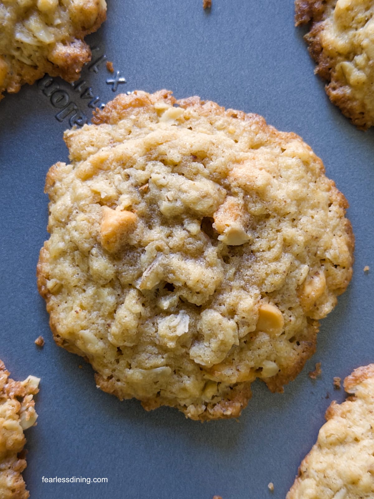 A close up of one gluten free butterscotch cookie on the baking sheet.
