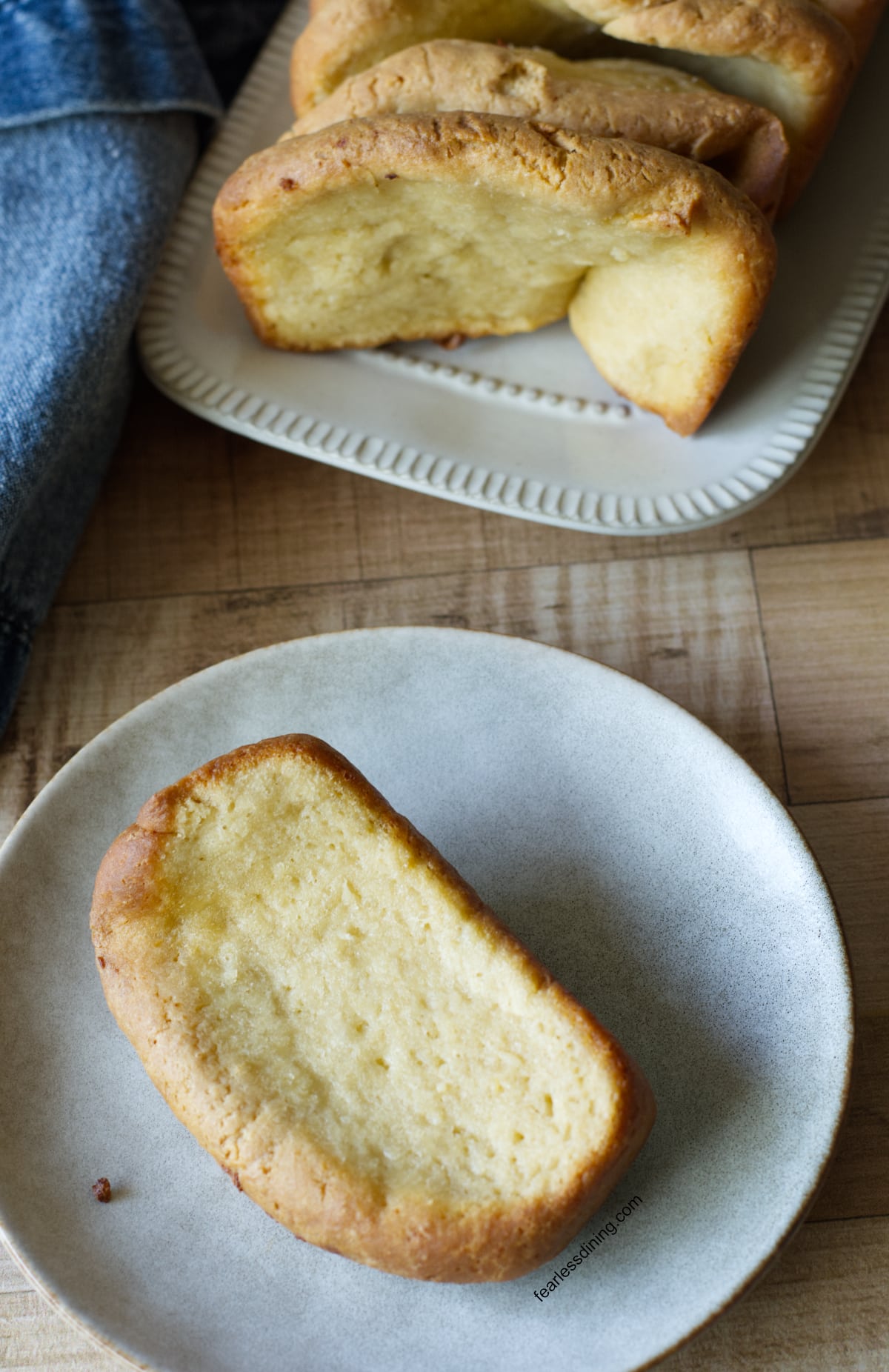 A slice of the garlic pull apart bread on a white plate.
