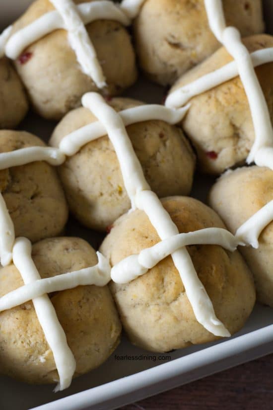 Baked gluten free hot cross buns in a baking dish.