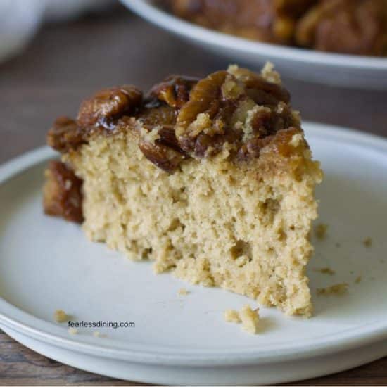 A slice of the gluten free pecan cake on a white plate.
