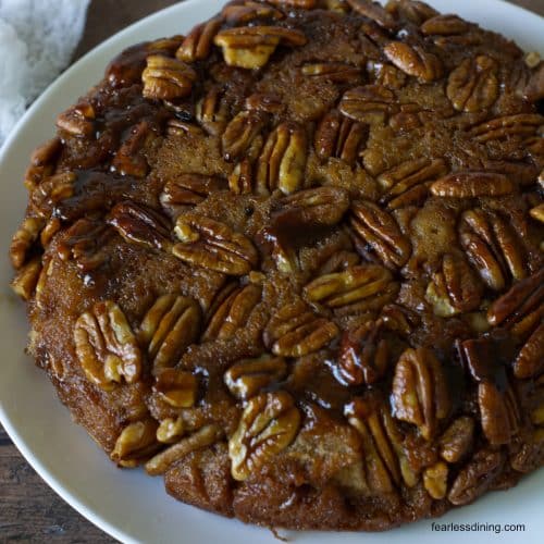 The gluten free pecan upside down cake on a plate ready to serve.