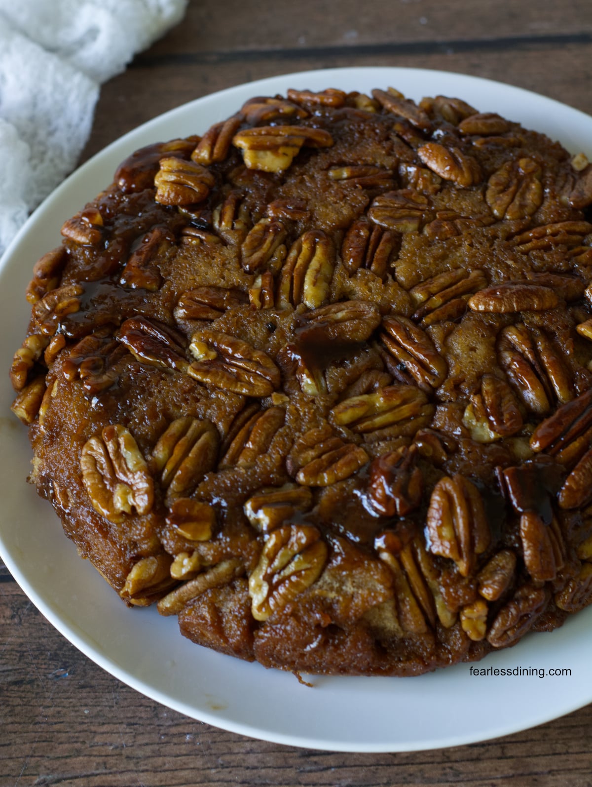 The gluten free pecan upside down cake on a plate ready to serve.