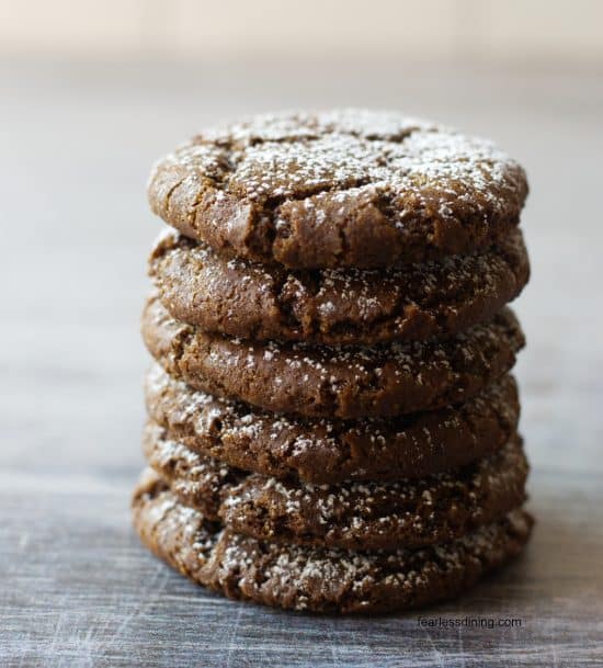 A stack of six gluten free spiced molasses cookies on a counter.