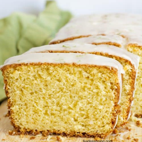 A close up of the gluten free olive oil cake with lime on a cutting board.