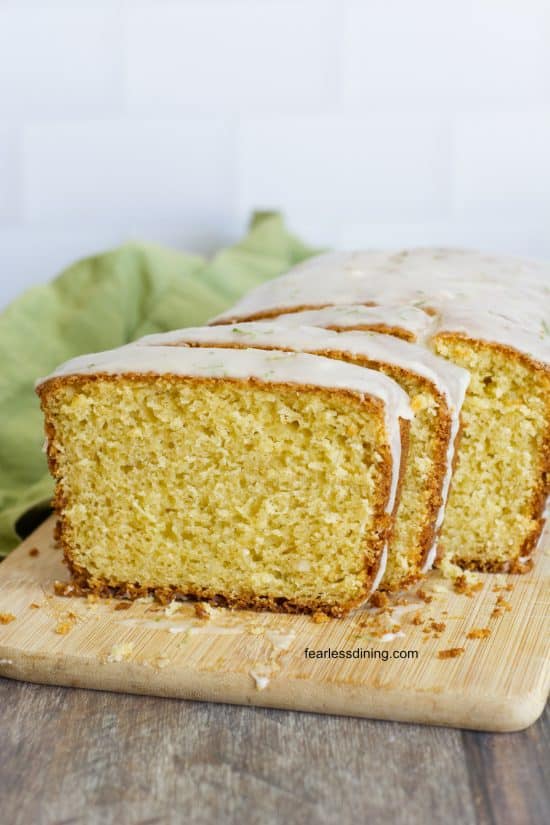 The gluten free olive oil cake sliced on a cutting board.