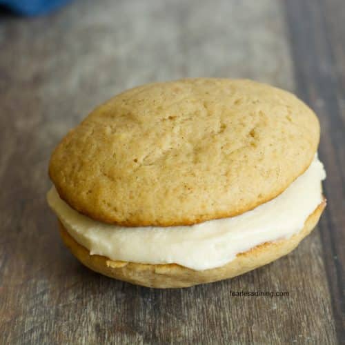 A single apple cider whoopie pie on the table.