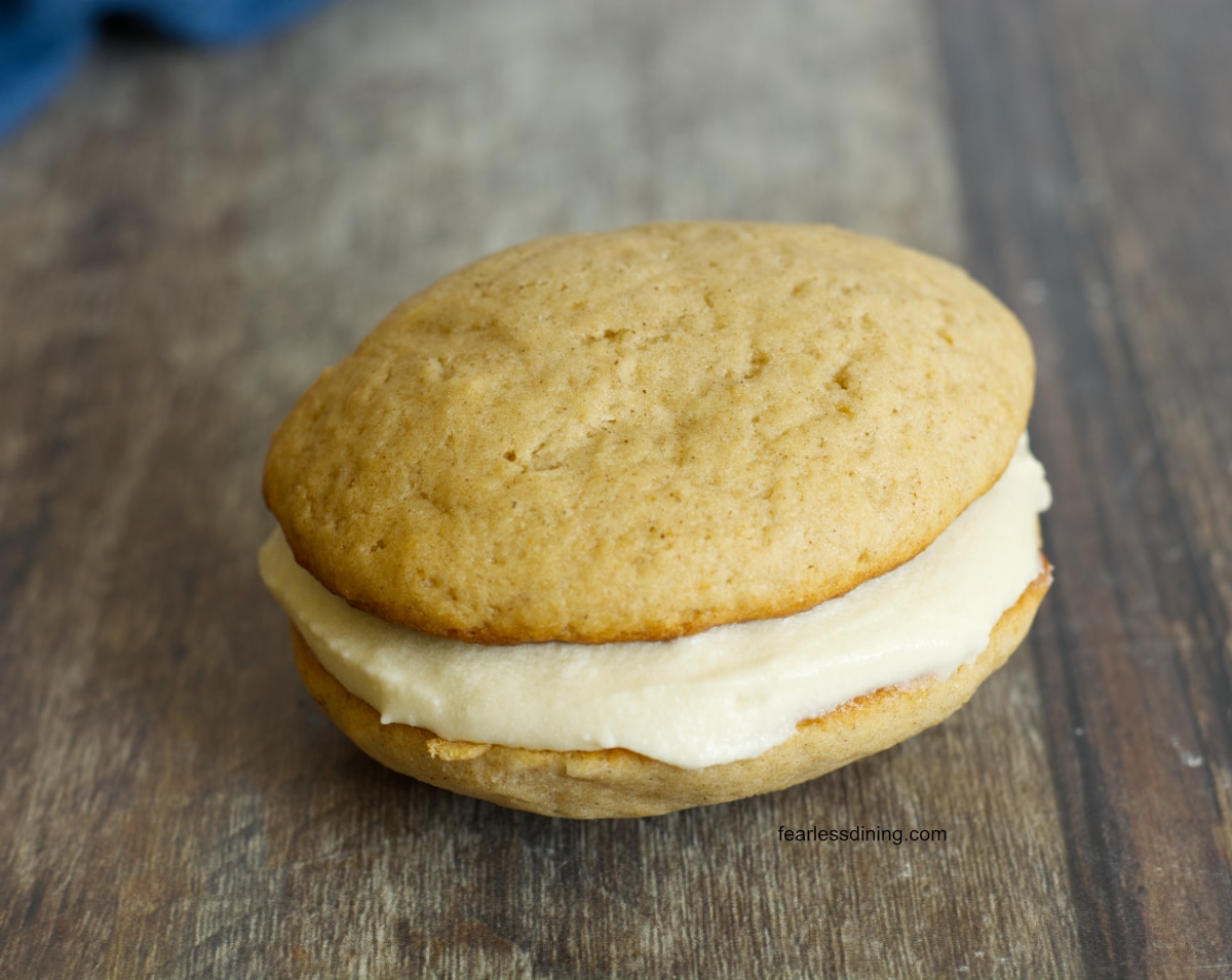 A single apple cider whoopie pie on the table.