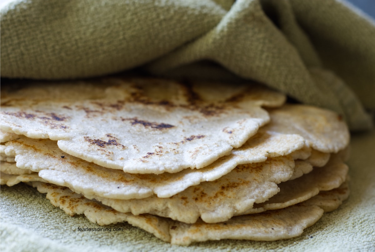 Cooked flour tortillas in the kitchen towel.