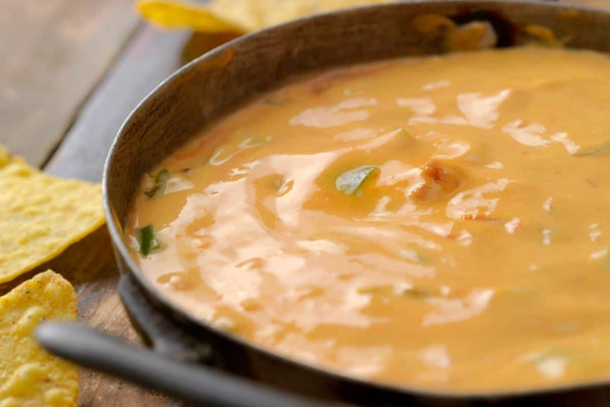 a bowl filled with melted cheese dip.