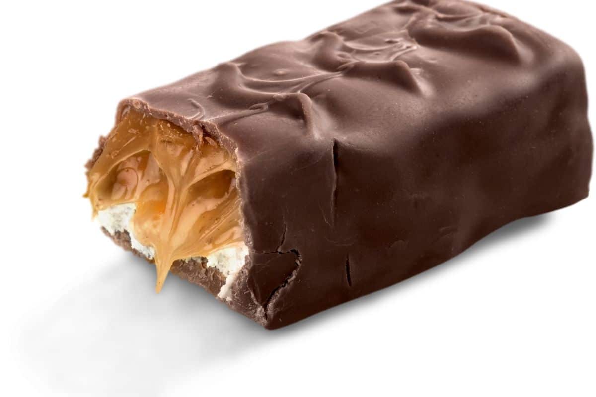 a milky way candy bar with a bite taken out so you can see inside.